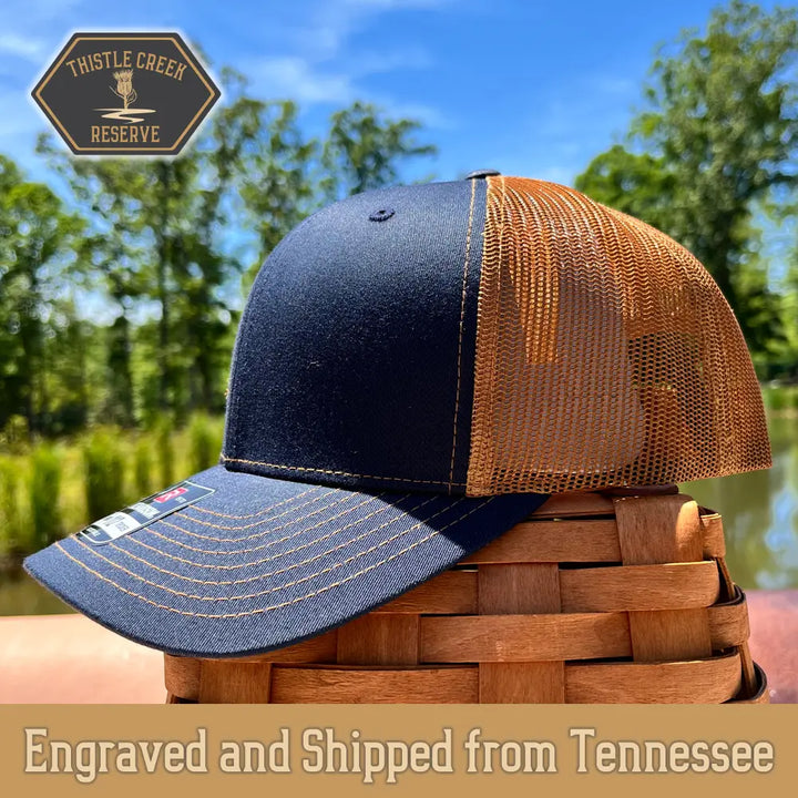 navy blue and tan hat